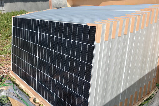 A STACK of solar panels awaits installation