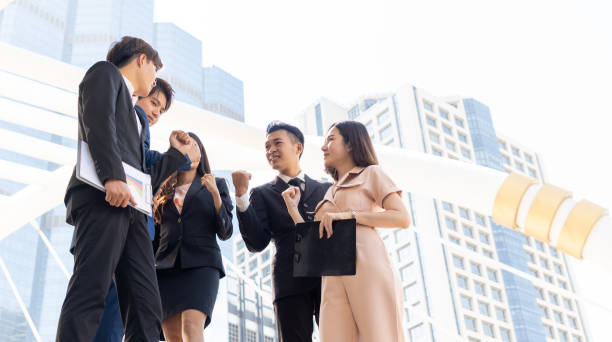 istock Successful young business group raise hand for celebrate. 1286976815