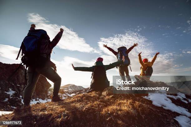 Hikers In Winner Poses Stands At Mountain Top Stock Photo - Download Image Now - Hiking, Mountain, Group Of People