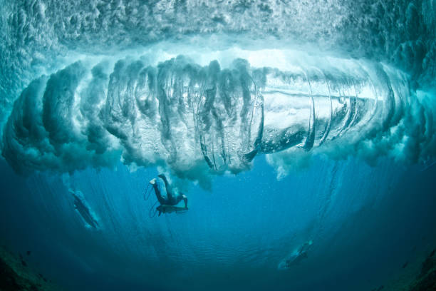 istock Surfers avoiding the extreme turbulence of a breaking wave. 1286977877