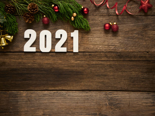 istock 2021 Year Figures With Christmas Decorations On Rustic Wooden Background 1286984177
