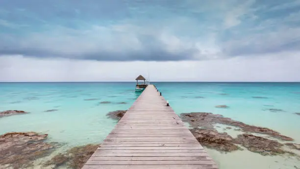 Fakarava Island Lagoon Jetty Panorama. Wooden pier leading from the beach into the beautiful turquoise south pacific ocean lagoon of the Fakarava Atoll. Fakarava Island, Havaiki-te-araro - Farea, Tuamotu Archipelago, French Polynesia, Oceania