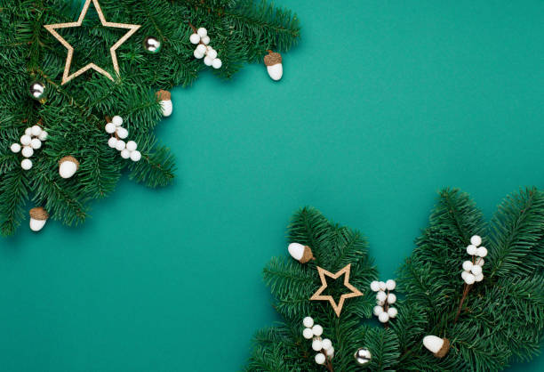 istock Xmas silver white decorations, acorns on green Christmas tree branches background. 1286985884