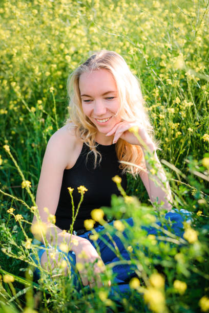 istock Girl posing in a rapeseed field 1286986941