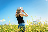 Girl posing in a rapeseed field