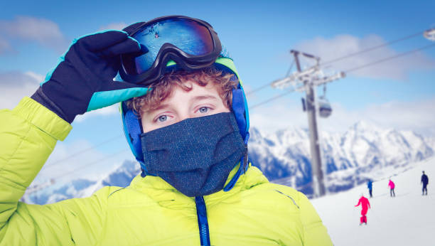 istock Boy on the ski slope with face mask 1286990881