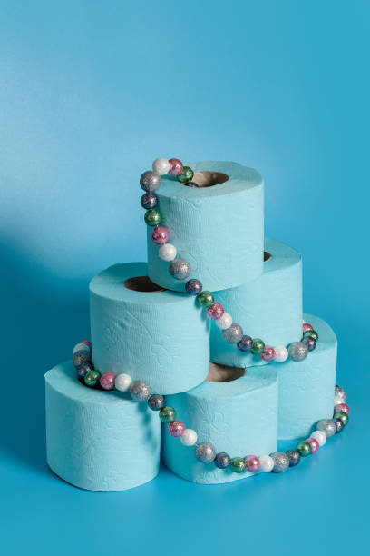 istock A stack of toilet paper, decorated with a Christmas tree garland. 1286991872