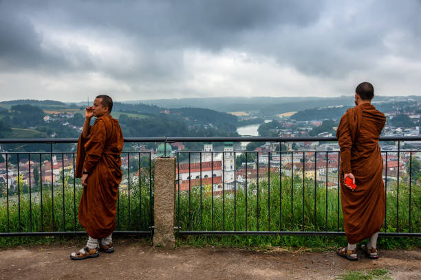 tibetan monks at vista point at veste oberhaus looking down on the city of passau, germany - inn history built structure architecture imagens e fotografias de stock