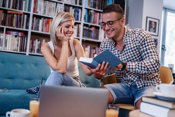 istock Couple of international students are studying in library. 1286992110