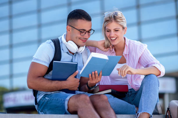 istock Photo of young colleagues reading a book 1286992120