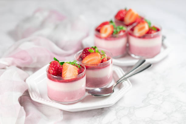 Traditional italian dessert vanilla strawberry panna cotta Traditional italian dessert vanilla strawberry panna cotta in a glass with fresh berries on a marble background. mousse dessert stock pictures, royalty-free photos & images