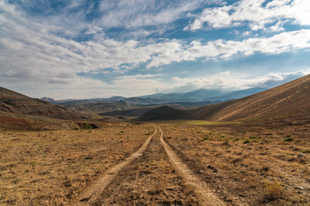 Dirt road to the mountains stock photo