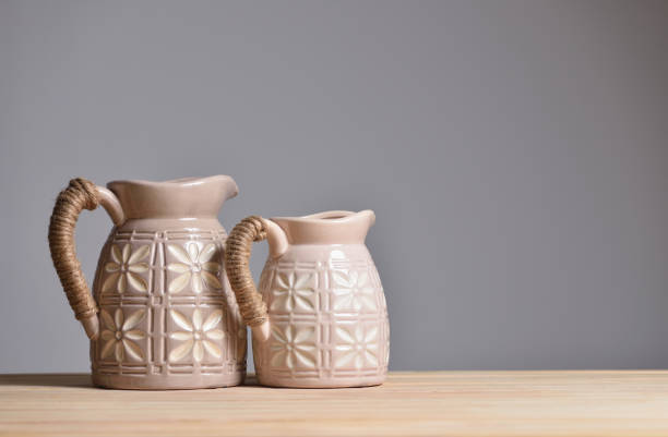 Two beige ceramic jugs for home decoration and flowers.