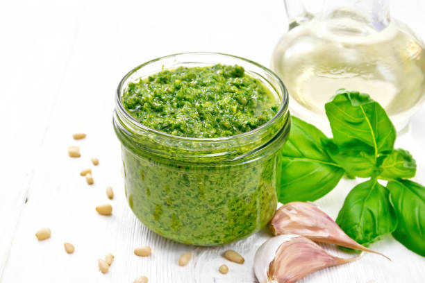 istock Pesto in jar on white board 1286995281