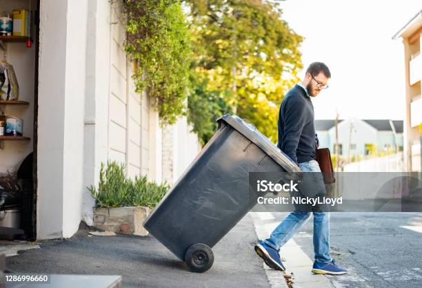 Hauling Garbage Stock Photo - Download Image Now - Garbage, Removing, Garbage Bin