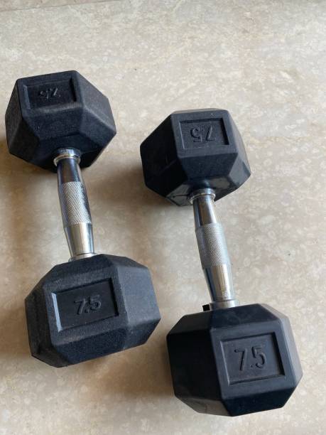 istock Two seven and a half kilogram hexagonal dumbbells on the floor 1286996880
