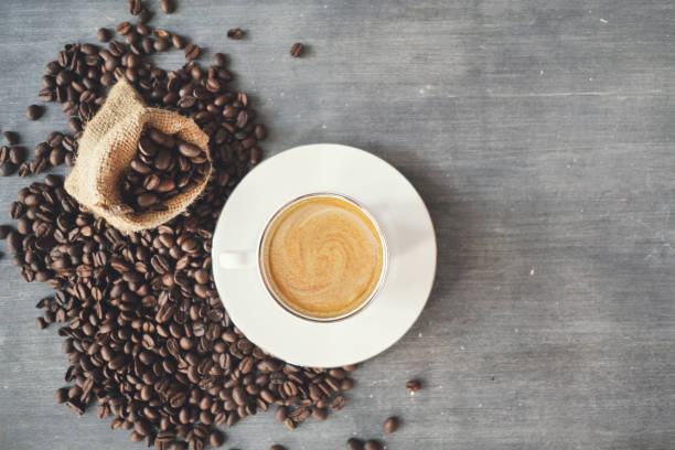 istock Coffee beans and coffee cups on the table 1286998970