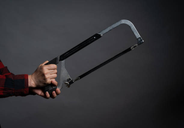 mano sosteniendo una sierra de mano - hammer isolated human arm holding fotografías e imágenes de stock
