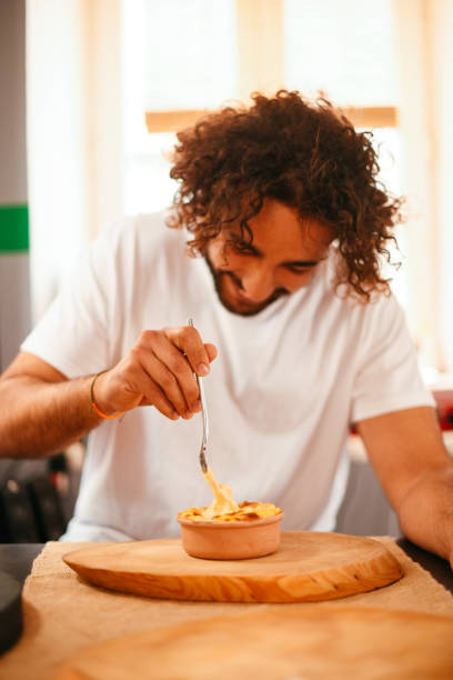 istock Young Man Eating Mac and Cheese 1286999581