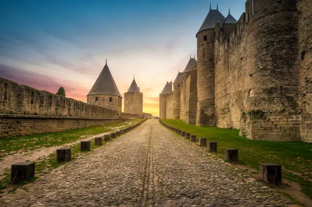 Walls and towers of medieval city of Carcassonne at sunset, France