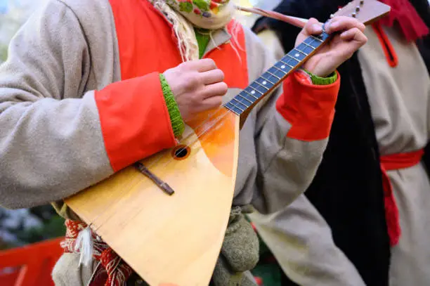 balalaika, russian, guitar, hand, playing, acoustic, artist, background, caucasian, closeup, clothes, clothing, cold, color, concept, costume, countryside, culture, day, entertainment, fingers, folk, hold, instrument, male, man, melody, music, musical, musician, national, natural, nature, old, outdoors, outside, people, performance, person, player, red, rural, rustic, song, sound, style, time, traditional, winter, wooden