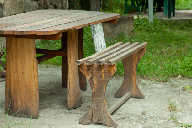 istock Beautiful picnic area with wooden table and blooming rhododendrons 1287002003