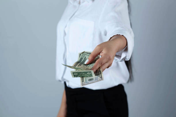 istock young woman hand money 1287008304