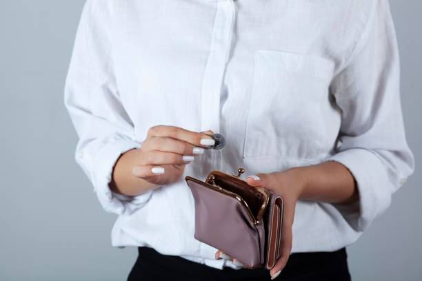 istock woman hand coin with wallet 1287009761