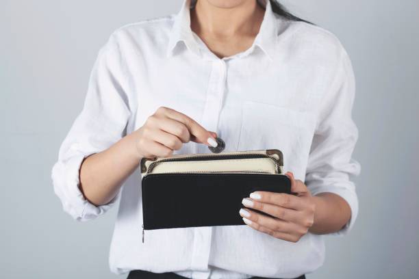 istock woman hand coin with wallet 1287009770