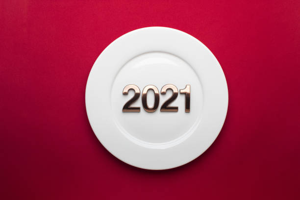 istock 2021 Happy New Year with white plate on red background. 1287010370