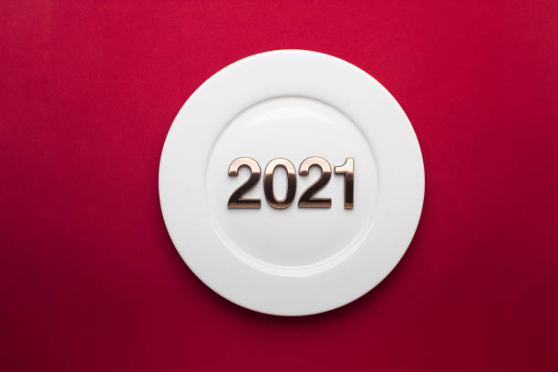 2021 Happy New Year with white plate on red background. stock photo