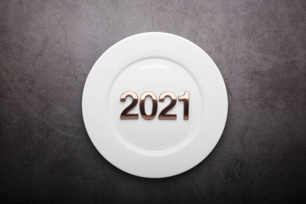 istock 2021 Happy New Year with white plate on Dark gray cement backgro 1287010868