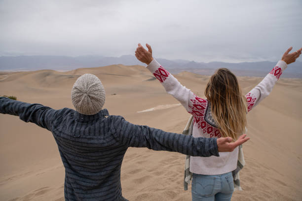 istock Couple embraces nature on sand dunes 1287012552