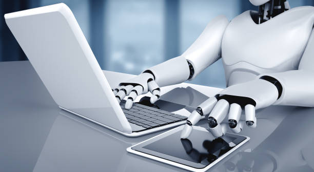 istock Robot humanoid use laptop and sit at table in future office 1287014069