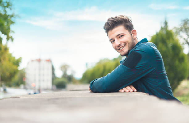 istock Happy young man in the city, shallow dof. 1287014247
