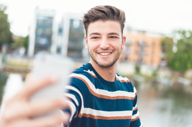 istock Smiling guy take selfie photo 1287014819