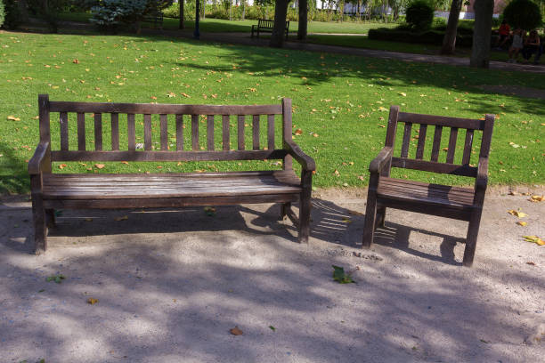 istock Wooden seat in a park 1287016015