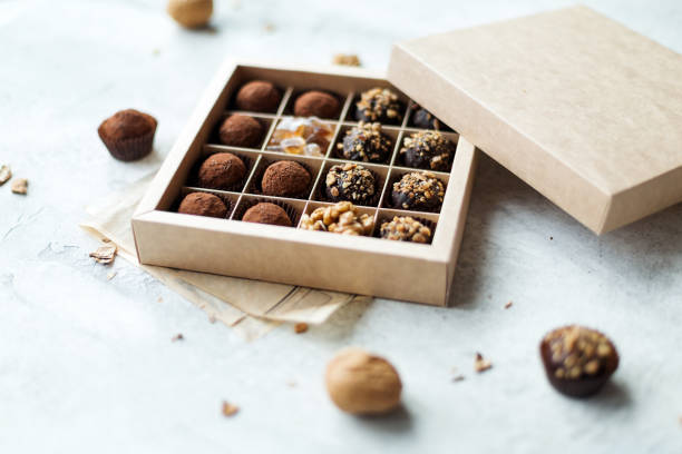 istock Chocolate truffle balls with cocoa powder in box 1287016231