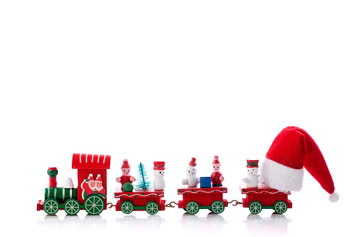 Toy of christmas train with Santa Claus Hat isolated on white background. New year celebration. Winter holidays
