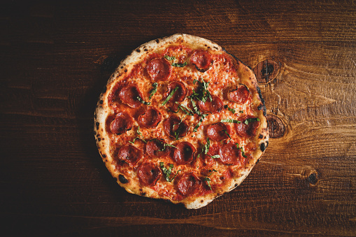 Pepperoni pizza on a wood surface
