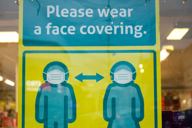 istock Please wear a face mask sign in shop window 1287023069
