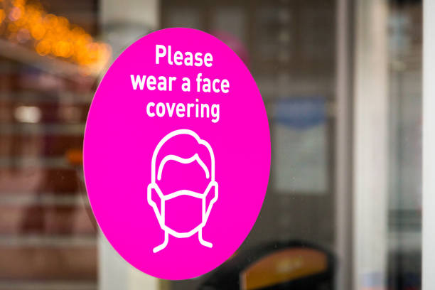 istock Please wear a face mask sign in shop window 1287023098