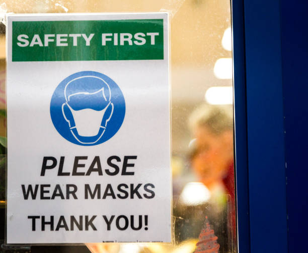 istock Please wear a face mask sign in shop window 1287023101