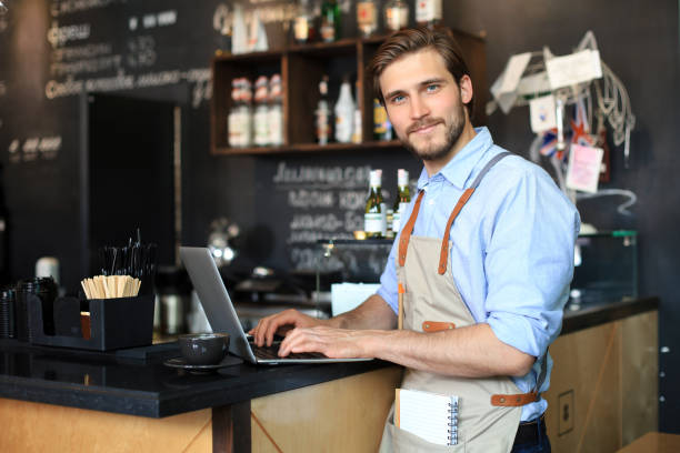 istock Restaurant manager working on laptop, counting profit. 1287024290