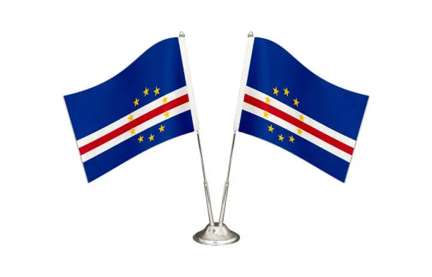 Cape Verde table flag isolated on white ground. Two flag poles with flags and Cape Verde flag on the table.