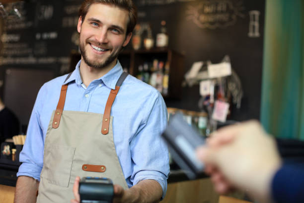 istock Customer using credit card for payment to owner at cafe restaurant, cashless technology. 1287024329