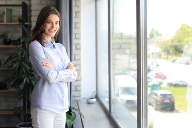istock Cheerful woman student professional standing at home in office looking at camera. 1287025230
