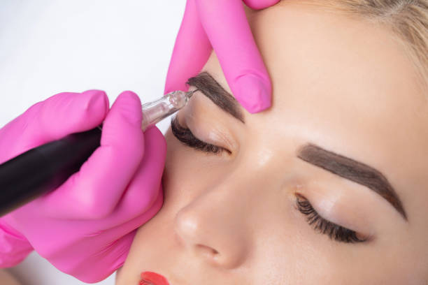 Permanent make-up for eyebrows of beautiful blonde woman in beauty salon. Closeup beautician doing eyebrows tattooing. Permanent make-up for eyebrows of beautiful blonde woman in beauty salon. Closeup beautician doing eyebrows tattooing. eyebrow stock pictures, royalty-free photos & images