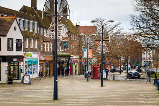 Crawley, UK - 21 November, 2020: the town centre of Crawley, West Sussex, UK, in the middle of lockdown during the covid pandemic at the end of 2020. The town centre is very quiet, with most shops shut, and people wearing face masks and social distancing.