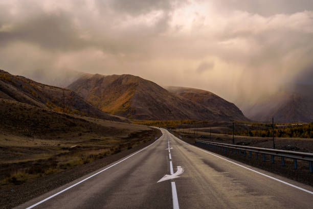 istock road asphalt mountains clouds sky rain weather 1287026750